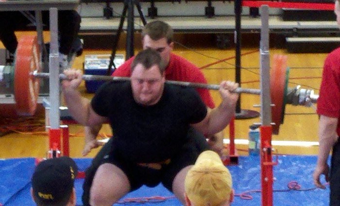 Carl Loser squatting at a powerlifting meet