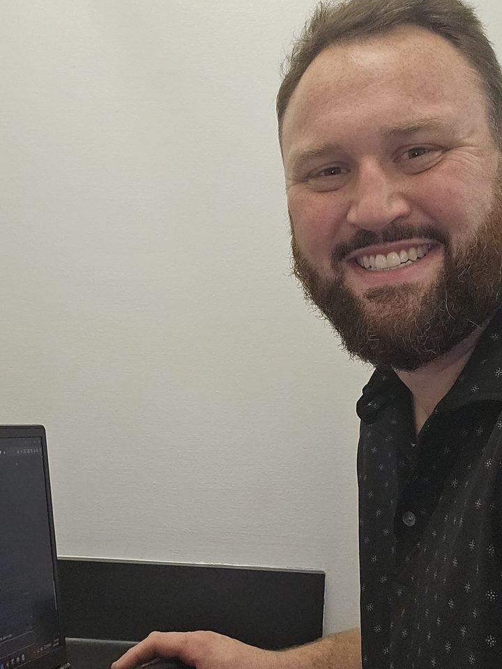 Carl Loser working on a laptop